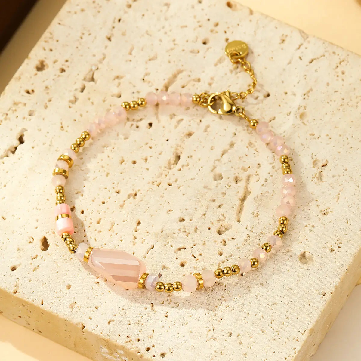 Pink and gold pearl bracelet with stone